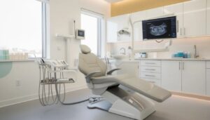 The image depicts a modern dental office featuring a comfortable patient chair and advanced imaging equipment, designed to facilitate procedures such as wisdom tooth extraction.